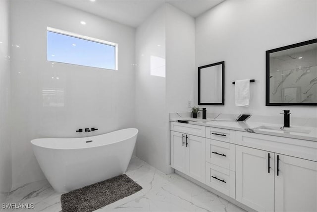 bathroom featuring double vanity, a soaking tub, marble finish floor, and a sink