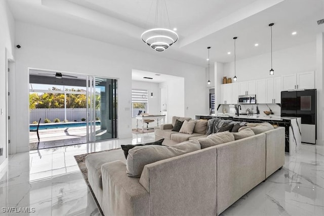 living room with visible vents, marble finish floor, recessed lighting, a high ceiling, and ceiling fan