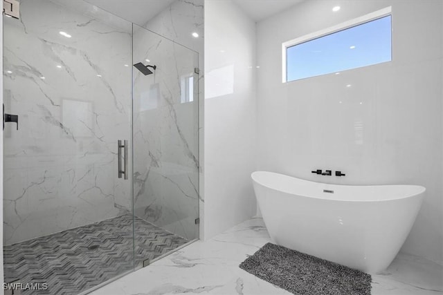 full bathroom featuring a soaking tub, marble finish floor, and a marble finish shower