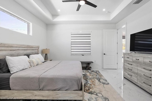 bedroom featuring a tray ceiling, visible vents, marble finish floor, and recessed lighting