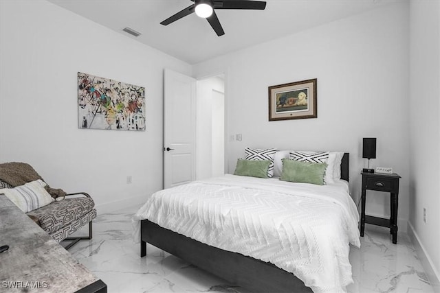 bedroom featuring visible vents, marble finish floor, a ceiling fan, and baseboards