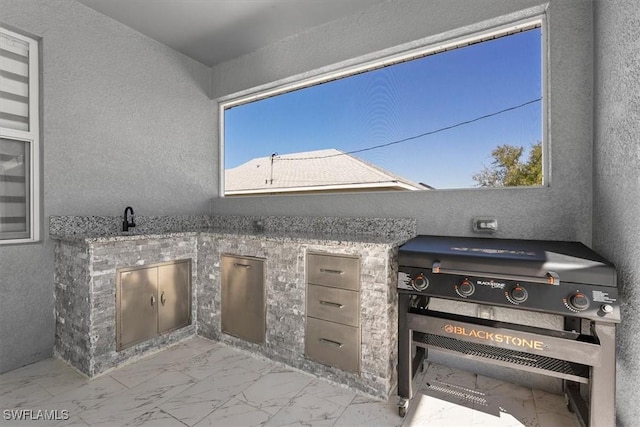 view of patio featuring a sink, area for grilling, and an outdoor kitchen