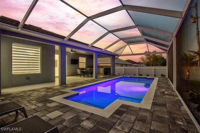 pool at dusk with a fenced in pool, a ceiling fan, a patio, and fence