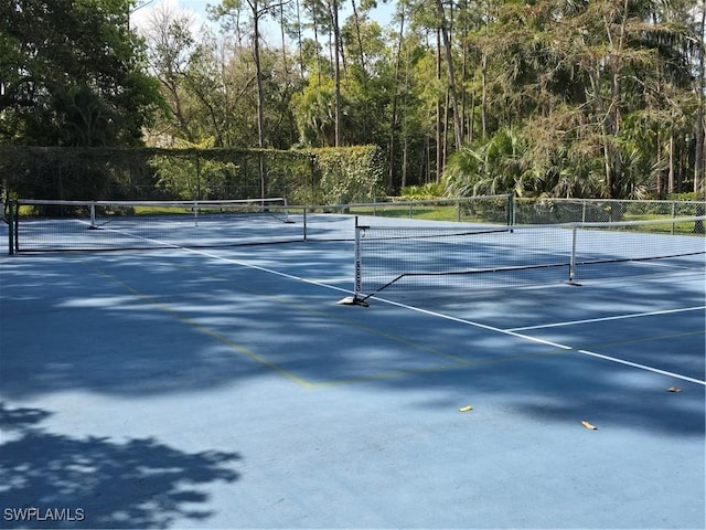 view of sport court with fence