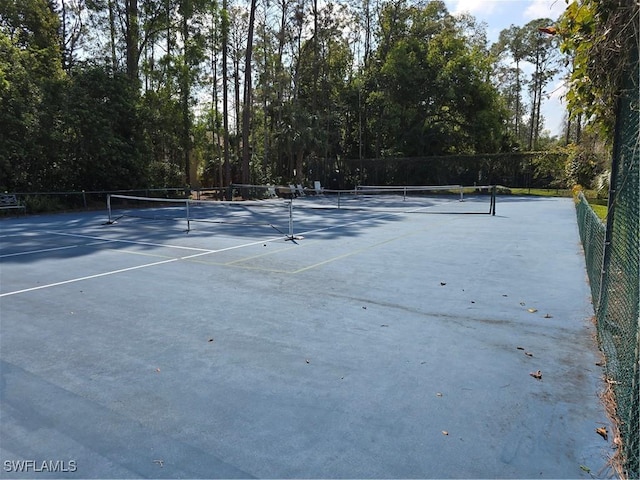 view of tennis court with fence