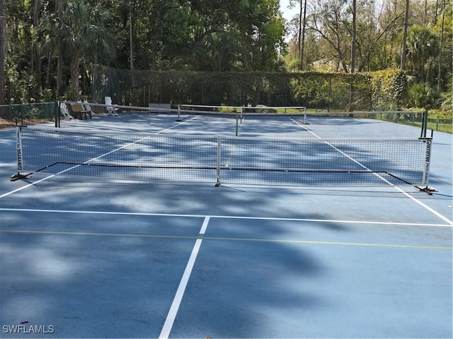 view of sport court featuring fence