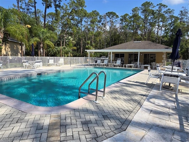 pool featuring a patio area and fence