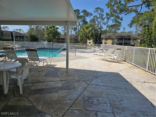 pool featuring a patio and fence