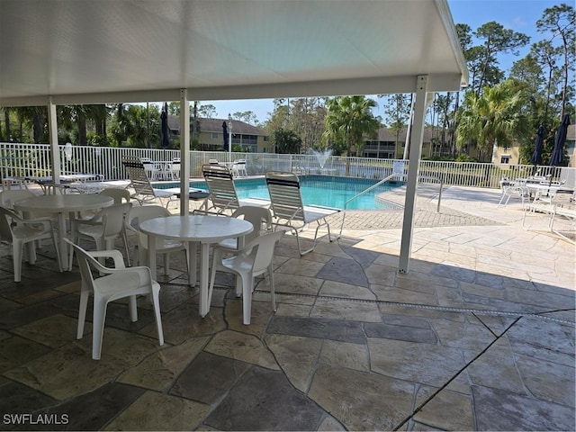 pool featuring a patio area and fence