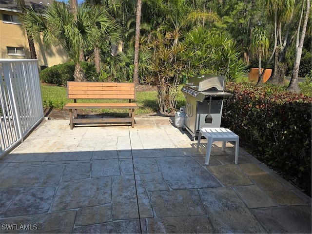 view of patio / terrace with fence and a grill