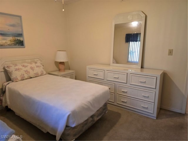 bedroom with dark colored carpet