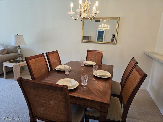 carpeted dining area with visible vents, baseboards, and an inviting chandelier