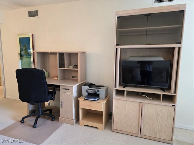 office space with light carpet, visible vents, and baseboards