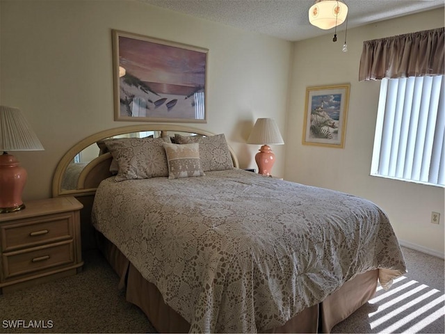 carpeted bedroom featuring a textured ceiling