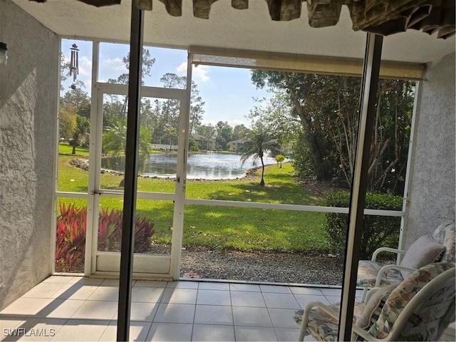 unfurnished sunroom featuring a water view