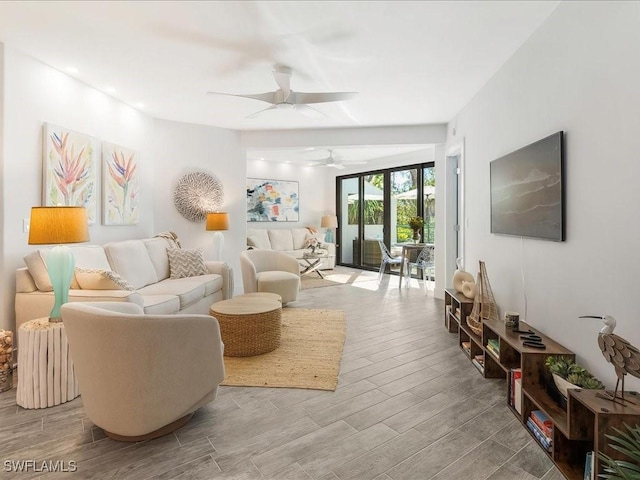 living area with a ceiling fan and light wood-type flooring