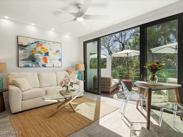 living room featuring recessed lighting, wood finished floors, and a ceiling fan