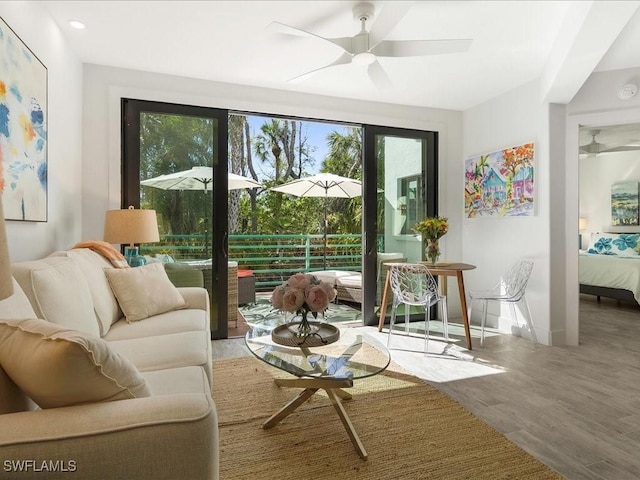 interior space with baseboards, wood finished floors, and a ceiling fan