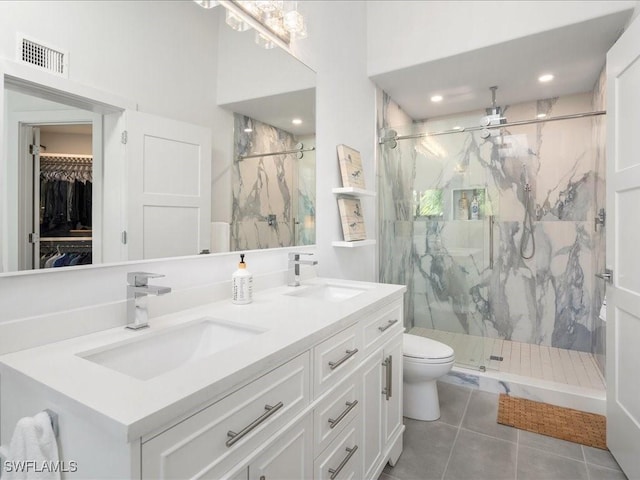 full bathroom featuring a marble finish shower, visible vents, toilet, and a sink