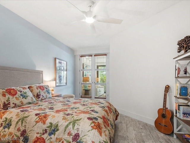 bedroom featuring a ceiling fan, wood finished floors, and baseboards