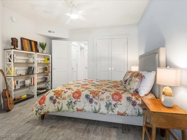 bedroom featuring a closet, visible vents, a ceiling fan, and wood finished floors