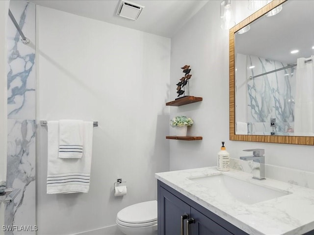 full bath featuring a marble finish shower, visible vents, toilet, and vanity