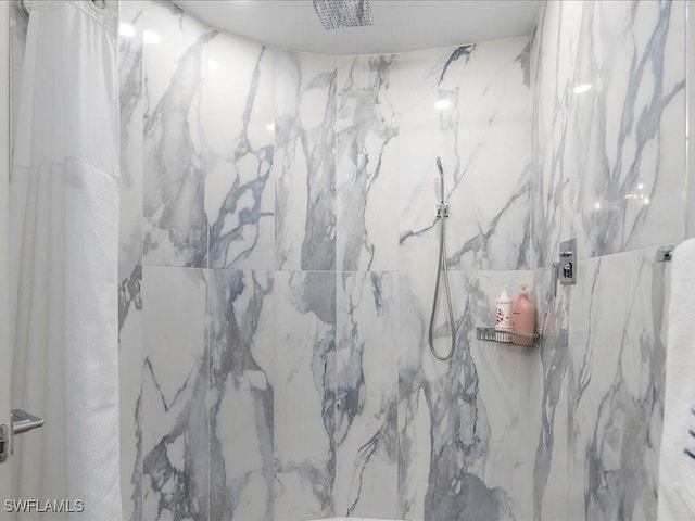 bathroom with a marble finish shower