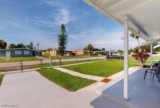 view of patio featuring a residential view, fence, and a gate