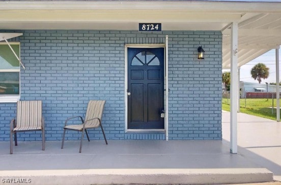 property entrance with brick siding