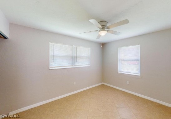 unfurnished room with a healthy amount of sunlight, baseboards, and ceiling fan