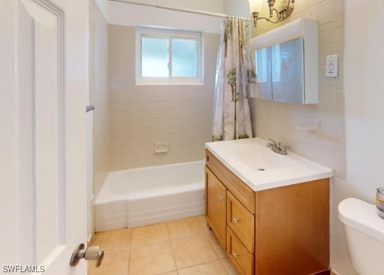 bathroom with vanity, shower / bath combination with curtain, toilet, and tile patterned flooring