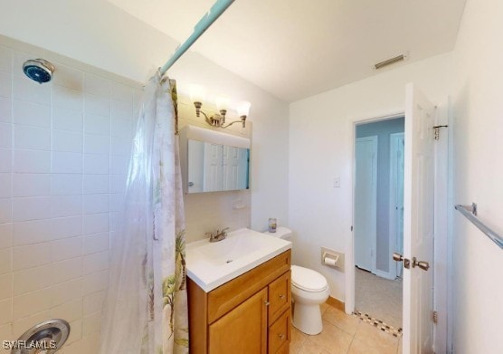 bathroom with visible vents, toilet, a shower with shower curtain, tile patterned floors, and vanity