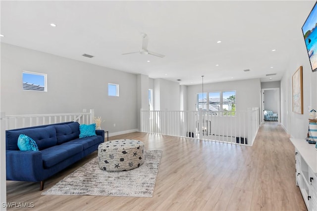 living room with light wood-style floors, recessed lighting, visible vents, and baseboards