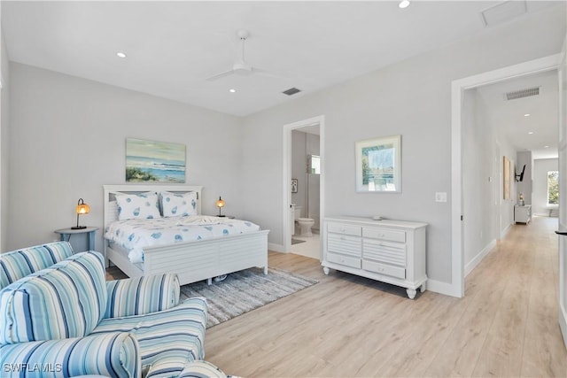 bedroom with light wood-type flooring, visible vents, and baseboards