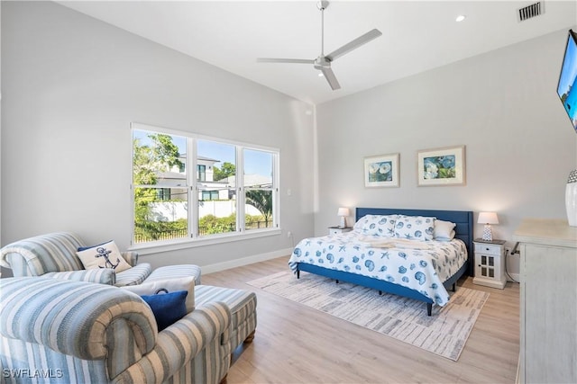 bedroom with visible vents, ceiling fan, light wood-style flooring, and baseboards