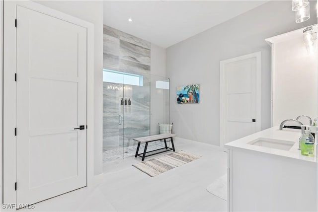 full bath with a marble finish shower and vanity