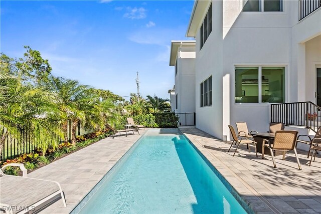 view of pool with a patio area, fence, and a fenced in pool