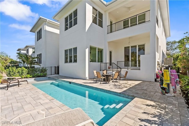 back of house featuring a patio, fence, and stucco siding