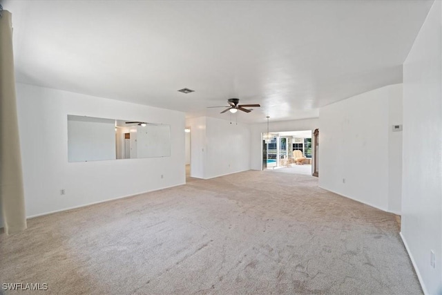 unfurnished room with visible vents, carpet floors, and ceiling fan