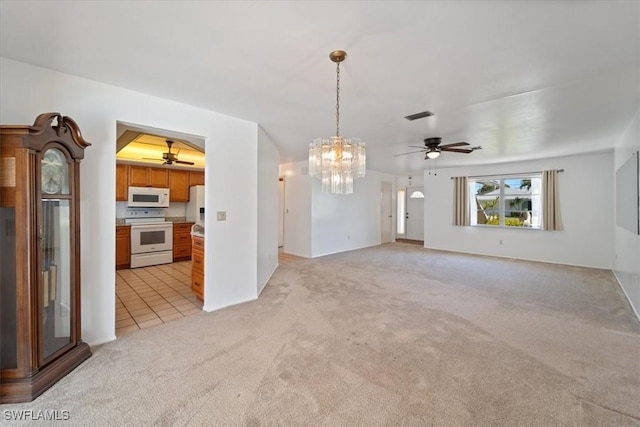 unfurnished living room with light tile patterned floors, visible vents, light colored carpet, and ceiling fan with notable chandelier