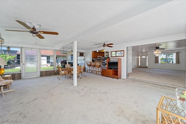 unfurnished living room featuring a textured ceiling and carpet flooring