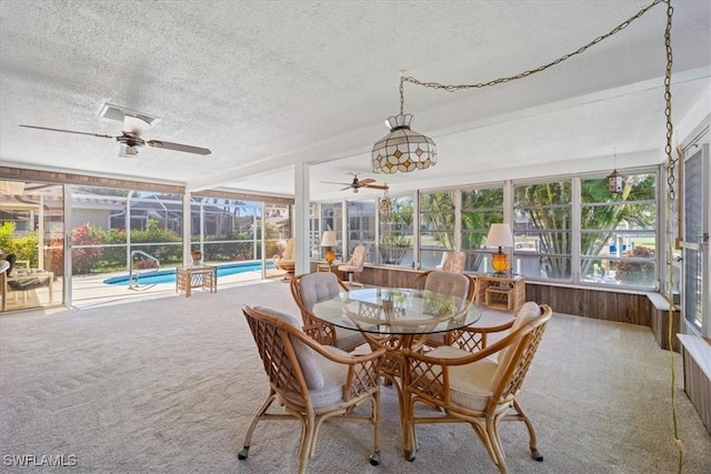 sunroom featuring a ceiling fan