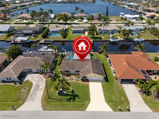 birds eye view of property with a residential view and a water view