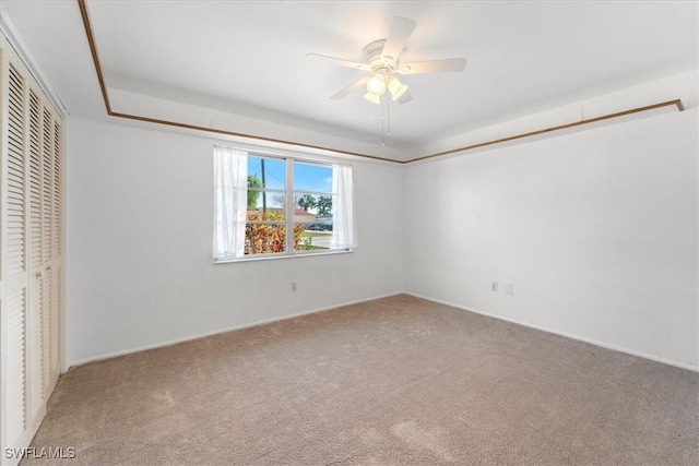 unfurnished bedroom with a closet, carpet floors, and a ceiling fan