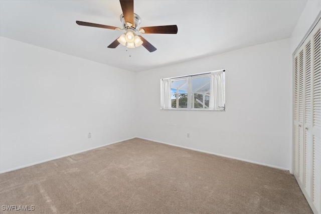 unfurnished bedroom with a closet, a ceiling fan, and carpet flooring