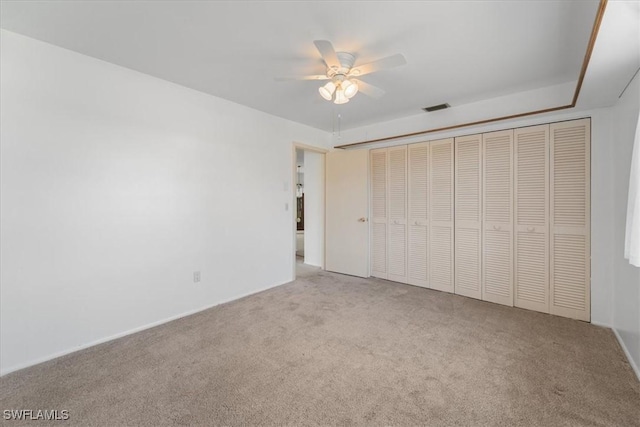 unfurnished bedroom with visible vents, a ceiling fan, and carpet flooring