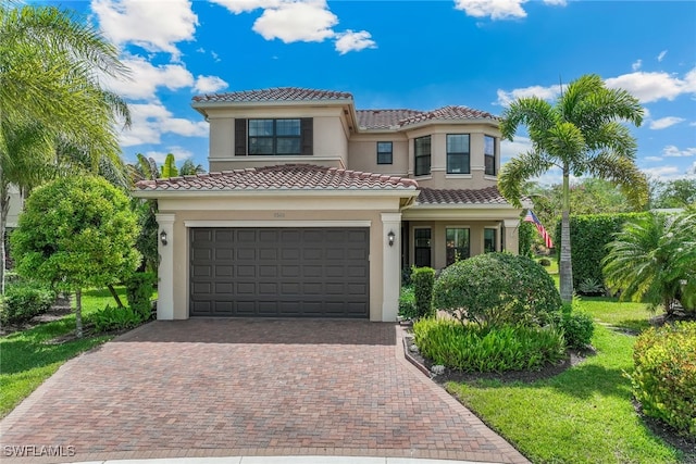 4360 Aurora St, Naples, FL 34119 - view of front of house with stucco siding, decorative driveway, a tile roof, and a garage