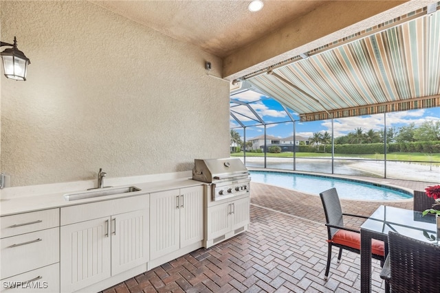4360 Aurora St, Naples, FL 34119 - view of patio / terrace with an outdoor kitchen, an outdoor pool, and a lanai