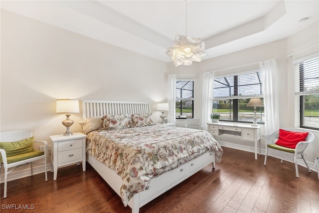 4360 Aurora St, Naples, FL 34119 - bedroom with dark wood finished floors, a chandelier, and a tray ceiling