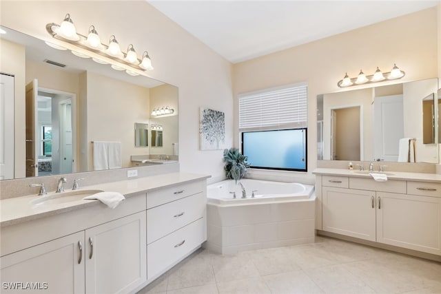 4360 Aurora St, Naples, FL 34119 - bathroom featuring two vanities, tile patterned floors, and a bath